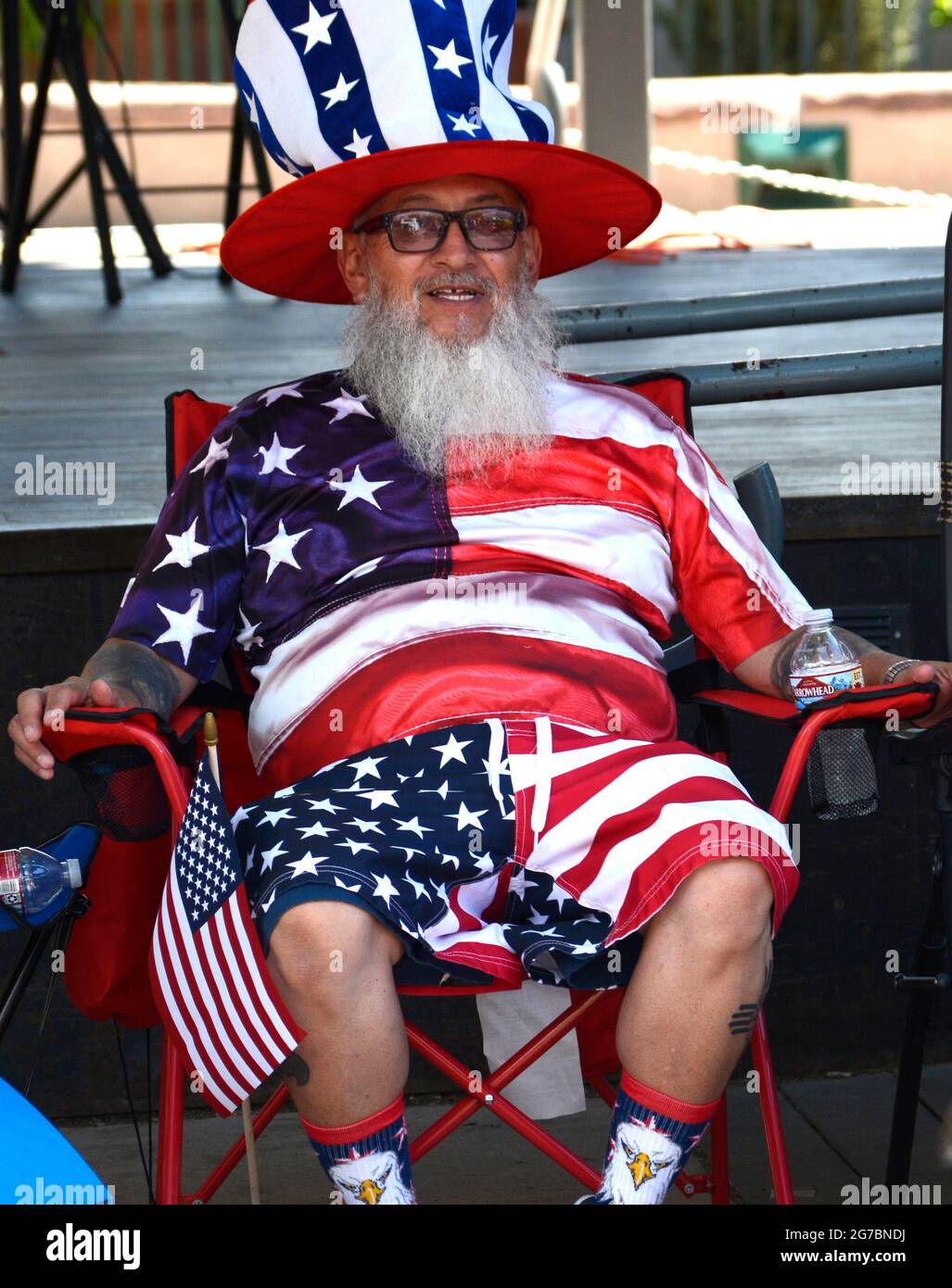 A man dressed in the colors of the American flag enjoys a Fourth of