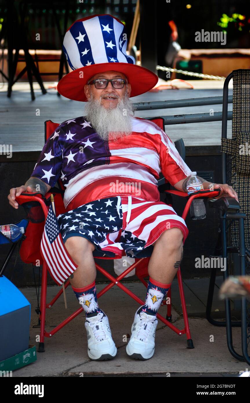 A man dressed in the colors of the American flag enjoys a Fourth of July car show in Santa Fe, New Mexico. Stock Photo