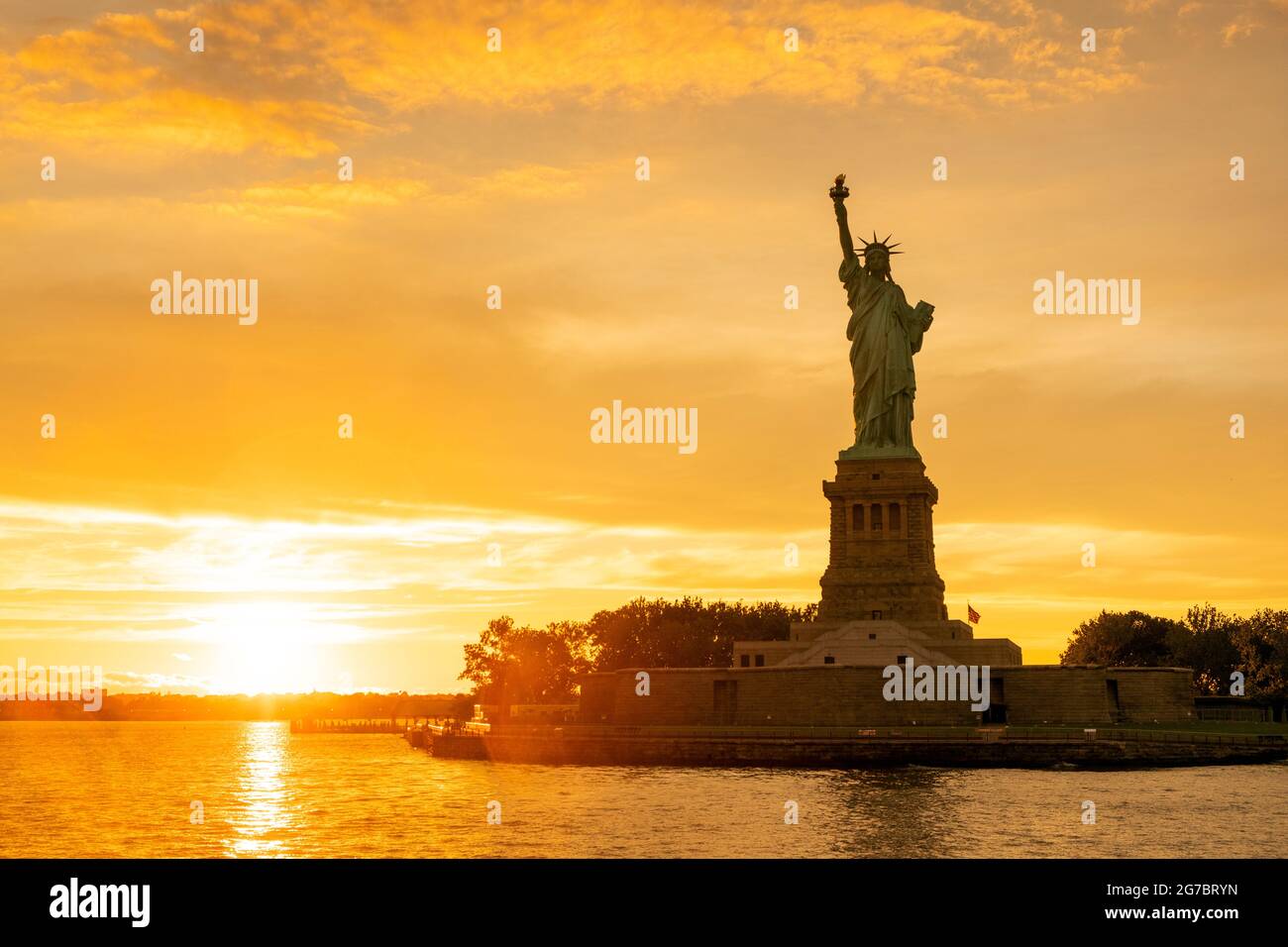 The Statue of Liberty at New York city during sunset Stock Photo