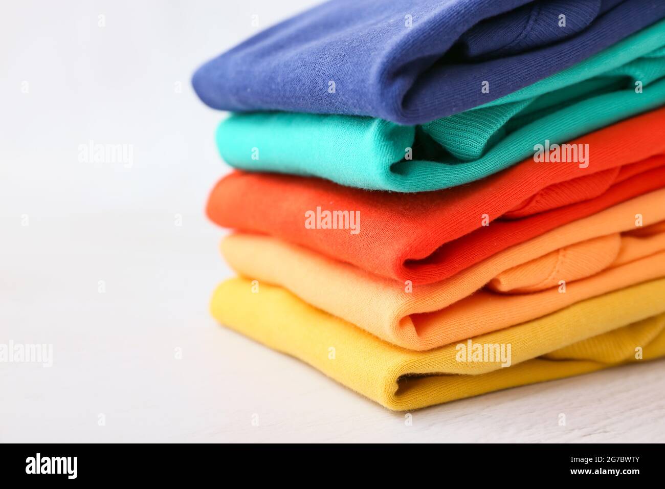 Stack of baby clothes on light background, closeup Stock Photo - Alamy