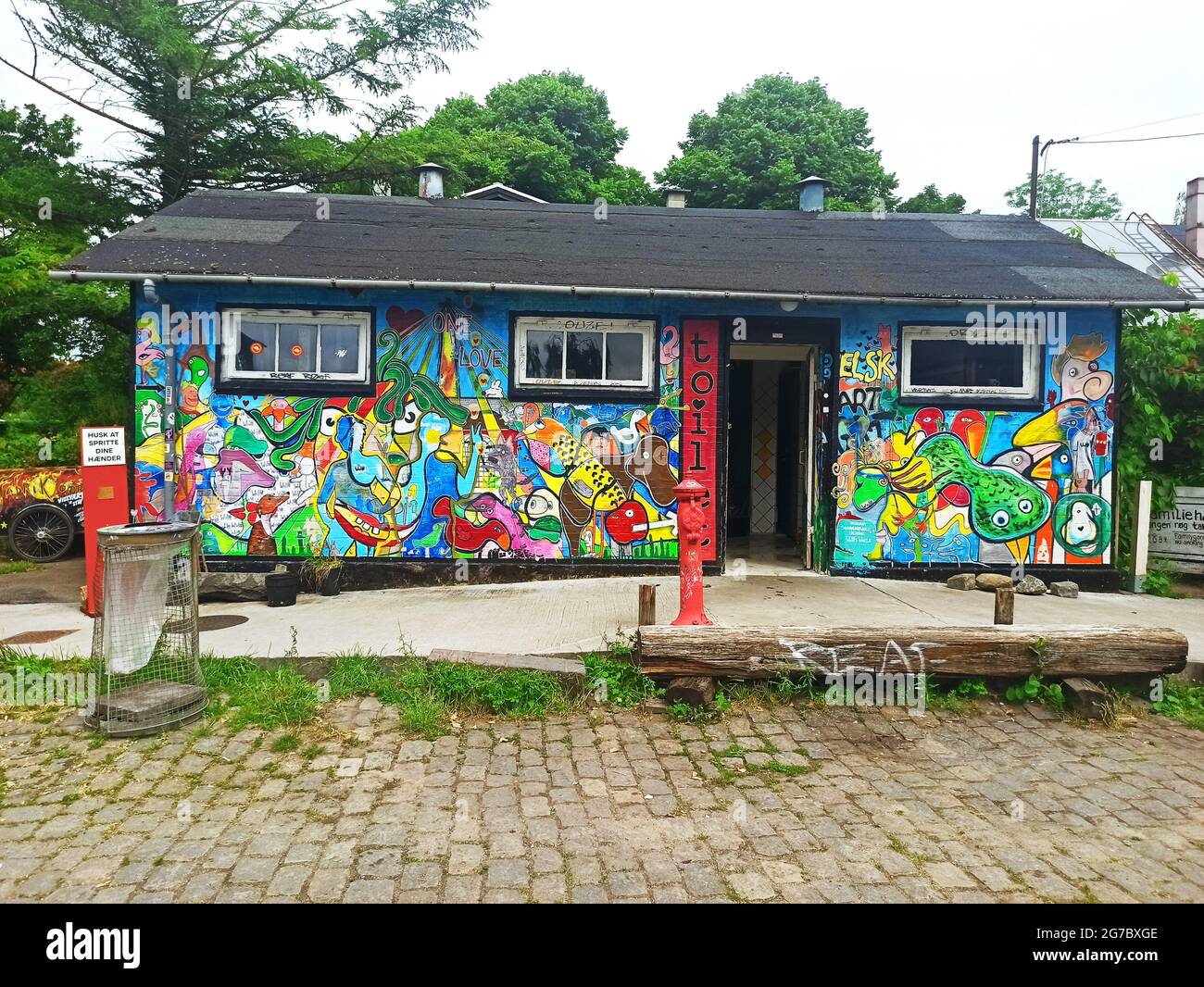 Copenhagen, Denmark - July 2021: Colorful graffiti wall of a public toilet building in Freetown Christiania Stock Photo
