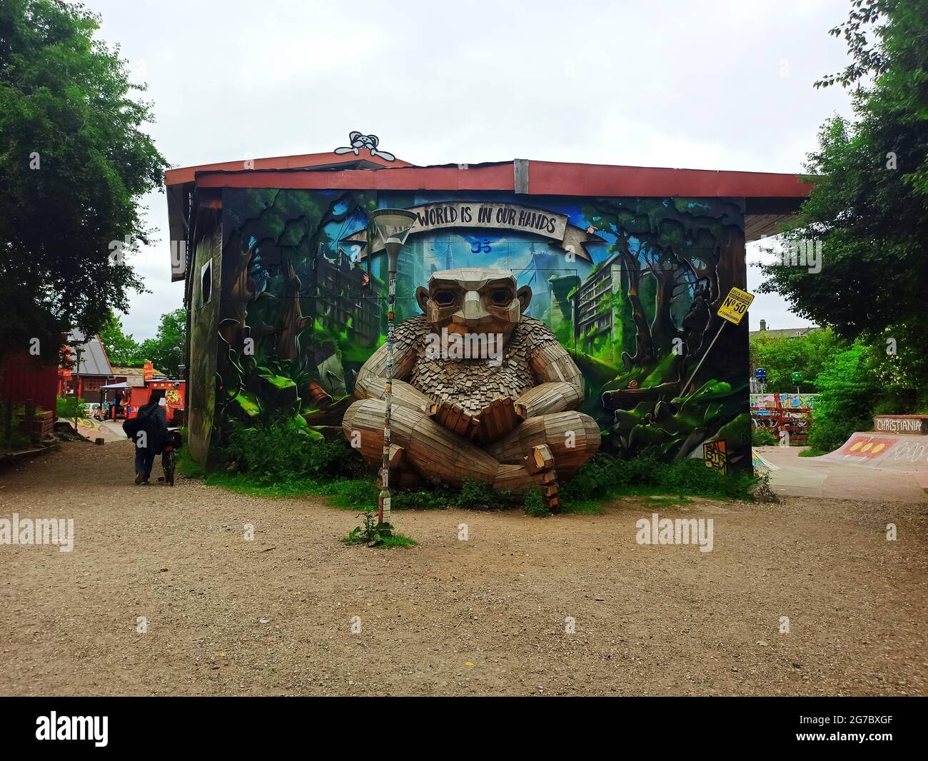 Copenhagen, Denmark - July 2021: GREEN GEORGE, also known as 'The World Is In Our Hands' trashed wooden art installation in Freetown Christiania Stock Photo