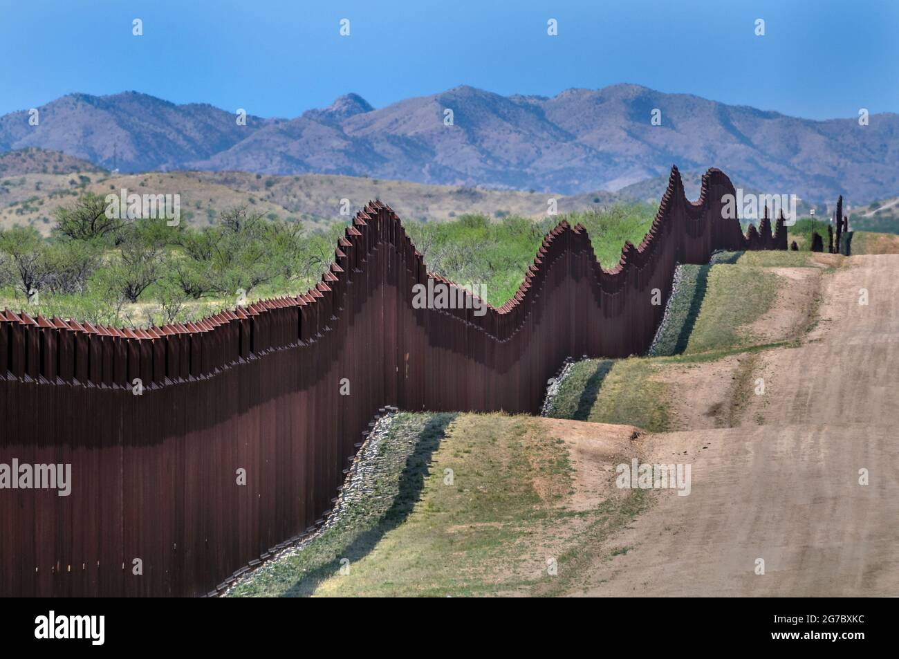 US border fence on the Mexico border, east of Nogales Arizona USA and Nogales Sonora Mexico, viewed from US side, looking west. This type of barrier i Stock Photo