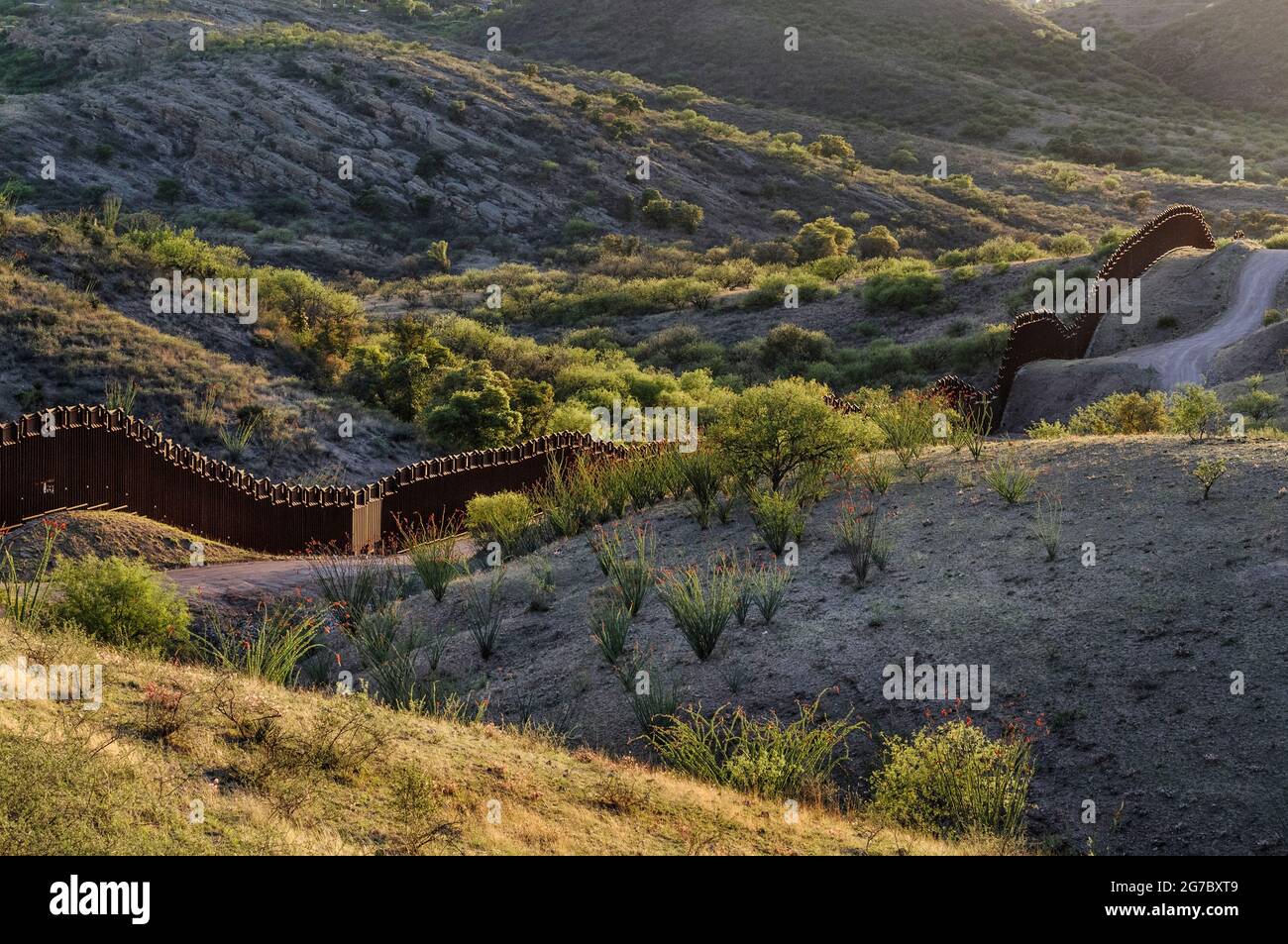 US border fence on the Mexico border, east of Nogales Arizona USA and Nogales Sonora Mexico, viewed from US side looking southwest. This location is a Stock Photo