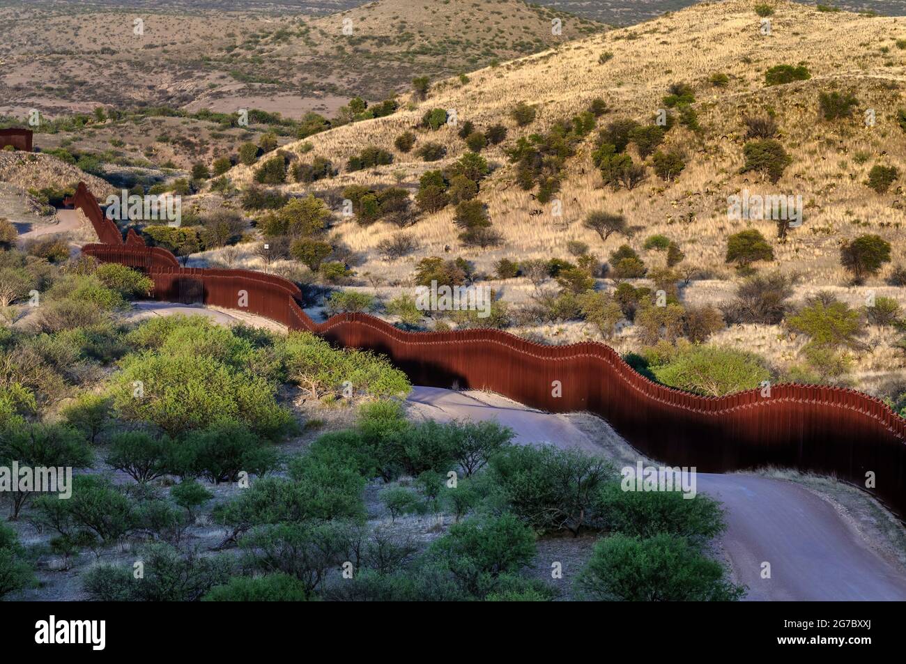 US border fence on the Mexico border, east of Nogales Arizona and Nogales Sonora Mexico, viewed from US side looking south east. This type of barrier Stock Photo