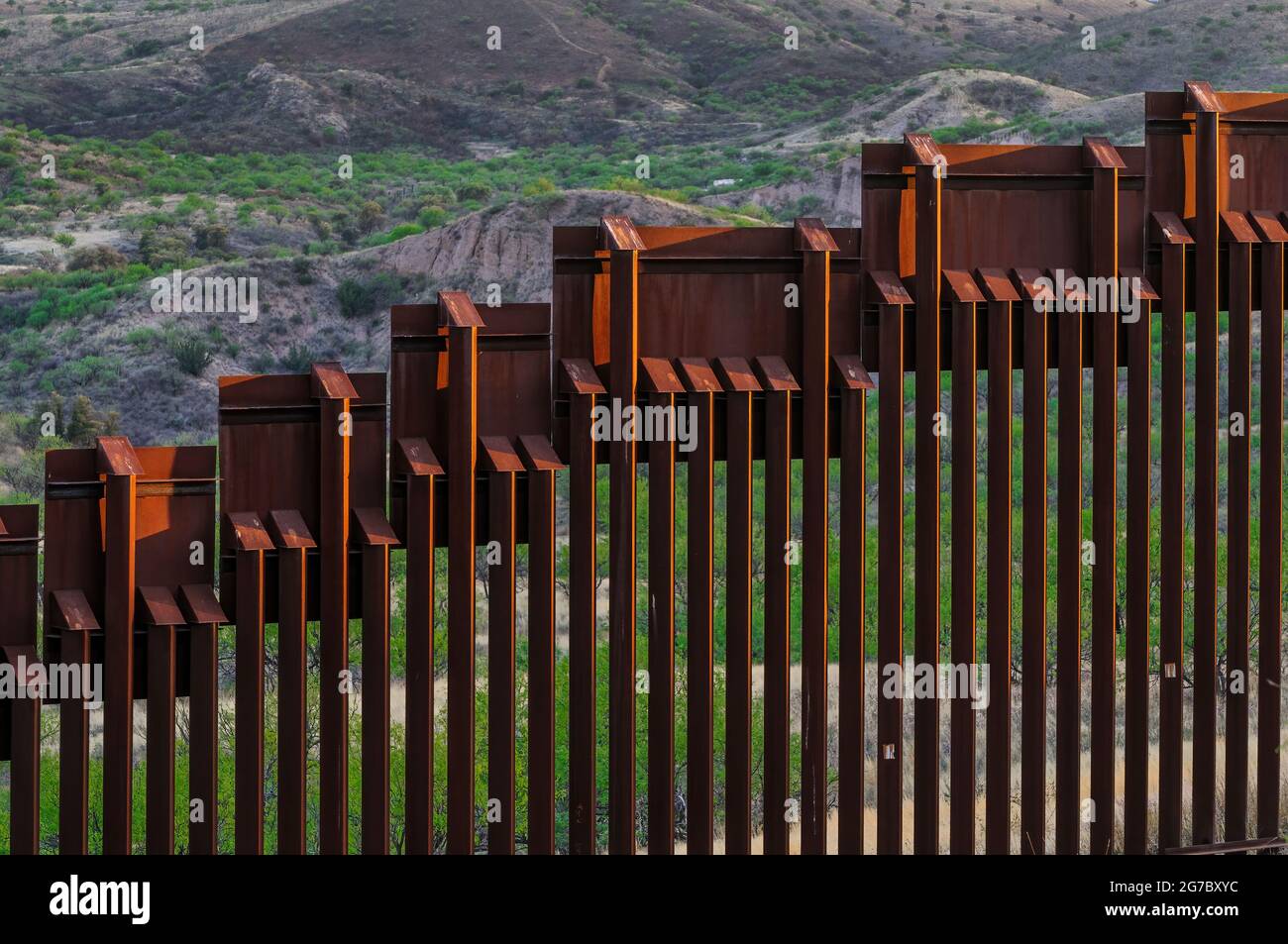 Detail view of top of US border fence on the Mexico border, east of Nogales Arizona USA and Nogales Sonora Mexico, viewed from US side. This type of b Stock Photo