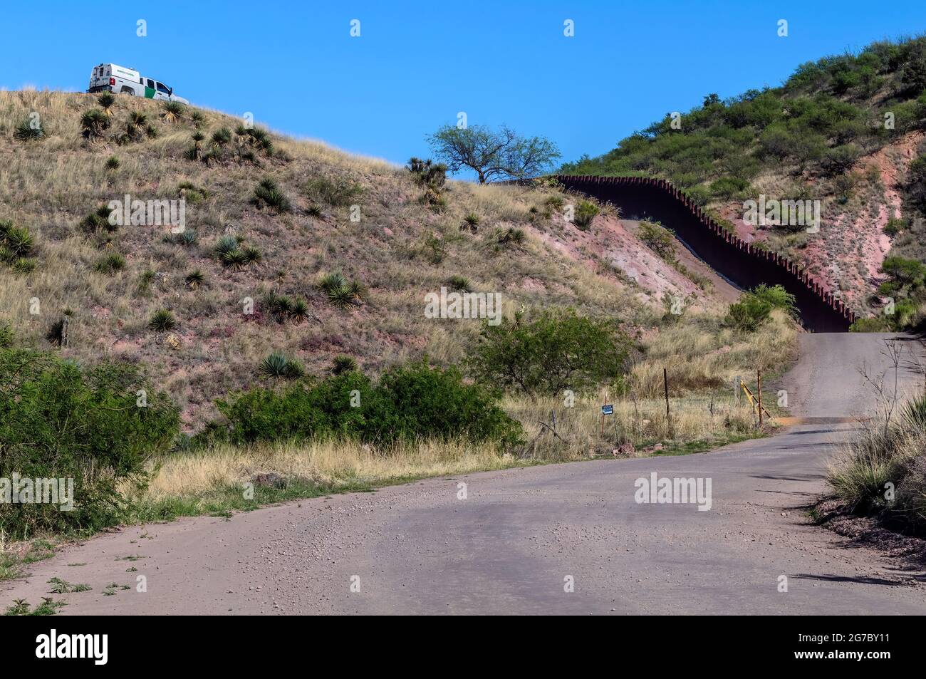 US border fence on the Mexico border, east of Nogales Arizona USA and Nogales Sonora Mexico, viewed from US side. This type of barrier is “bollard” st Stock Photo