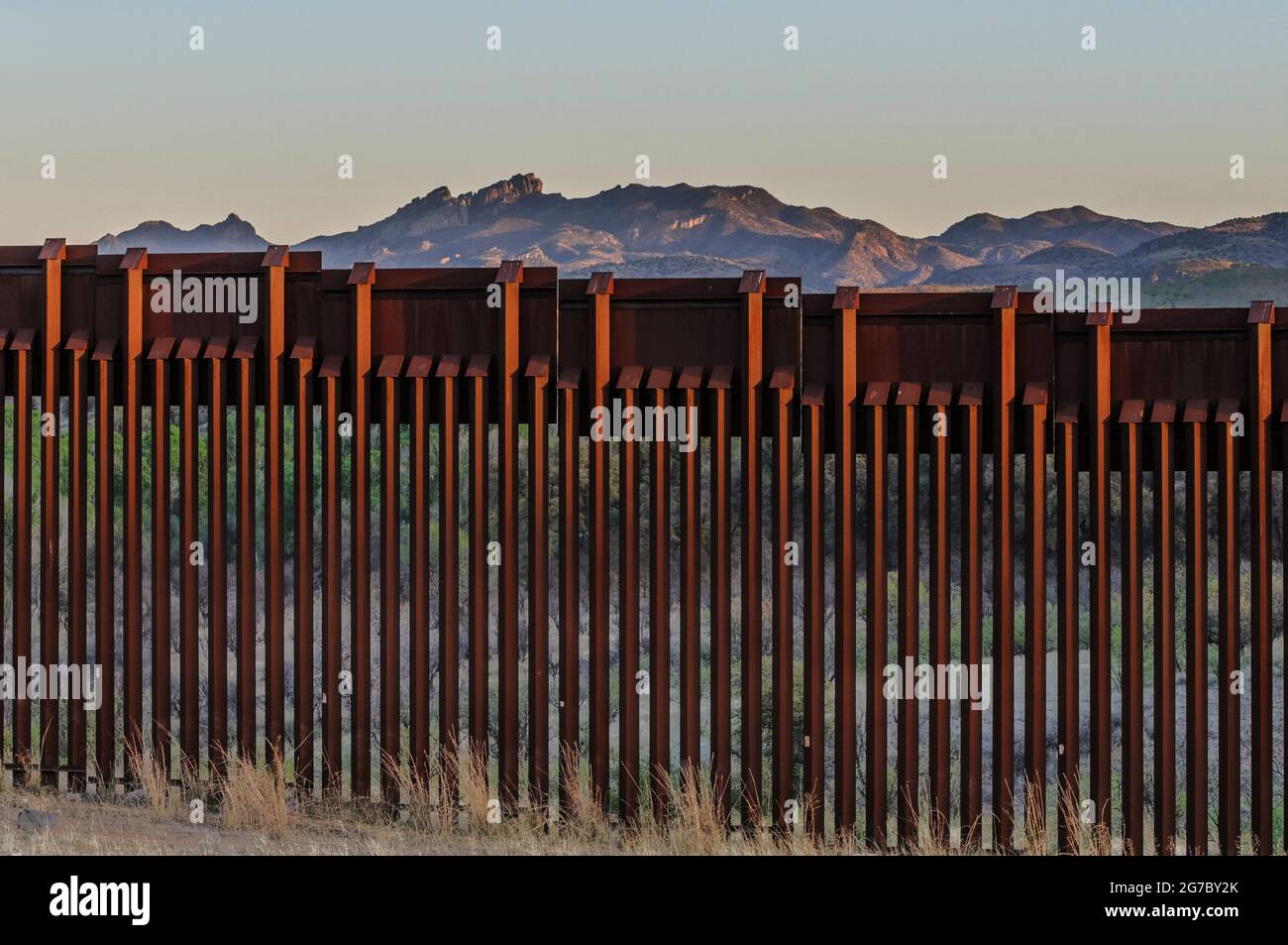 US border fence on the Mexico border, east of Nogales Arizona USA and Nogales Sonora Mexico, viewed from US side. This type of barrier is “bollard” st Stock Photo