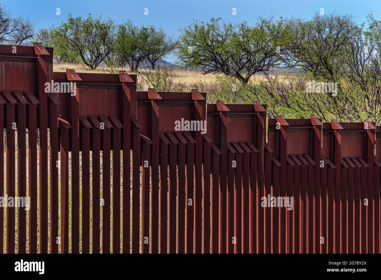 US border fence on the Mexico border, east of Nogales Arizona USA, and Nogales Sonora Mexico, viewed from US side. This type of barrier is “bollard” s Stock Photo