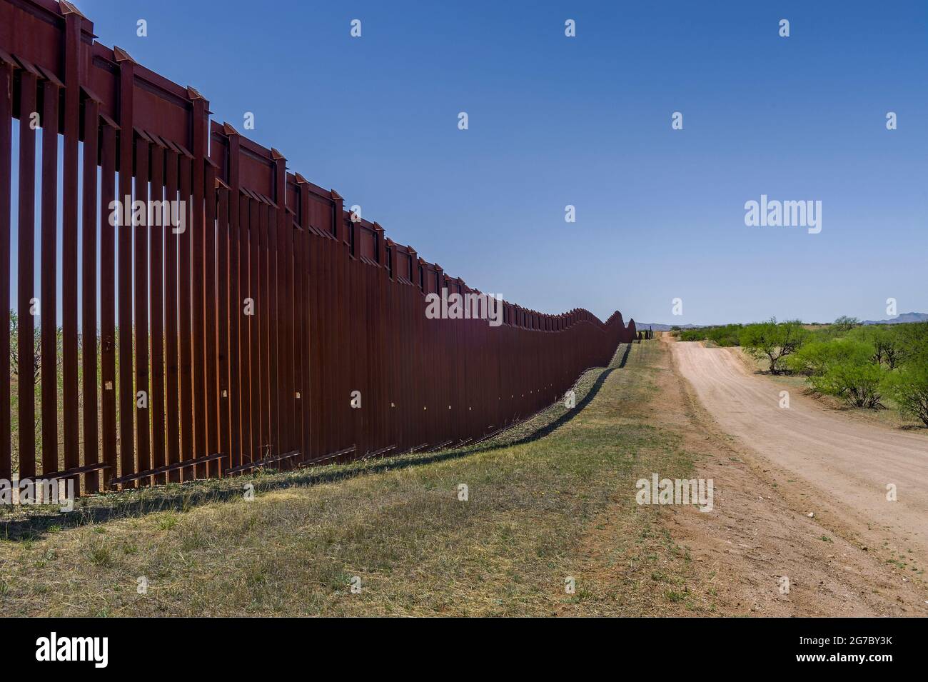 US border fence on the Mexico border, east of Nogales Arizona USA and Nogales Sonora Mexico, viewed from US side. This type of barrier is “bollard” st Stock Photo