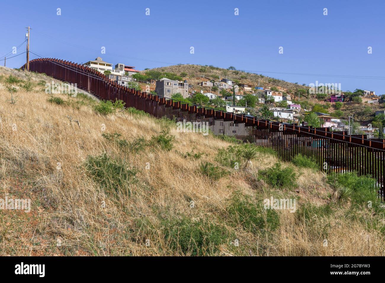 US border fence on the Mexico border, viewed from US side looking into Nogales Sonora Mexico just east of Port of Entry in downtown Nogales.  This typ Stock Photo