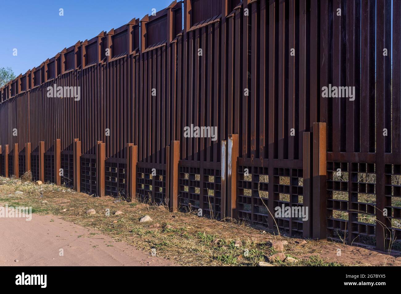 US border fence on the Mexico border, east of Nogales Arizona USA, and Nogales Sonora Mexico, viewed from US side. This type of barrier is “bollard” s Stock Photo