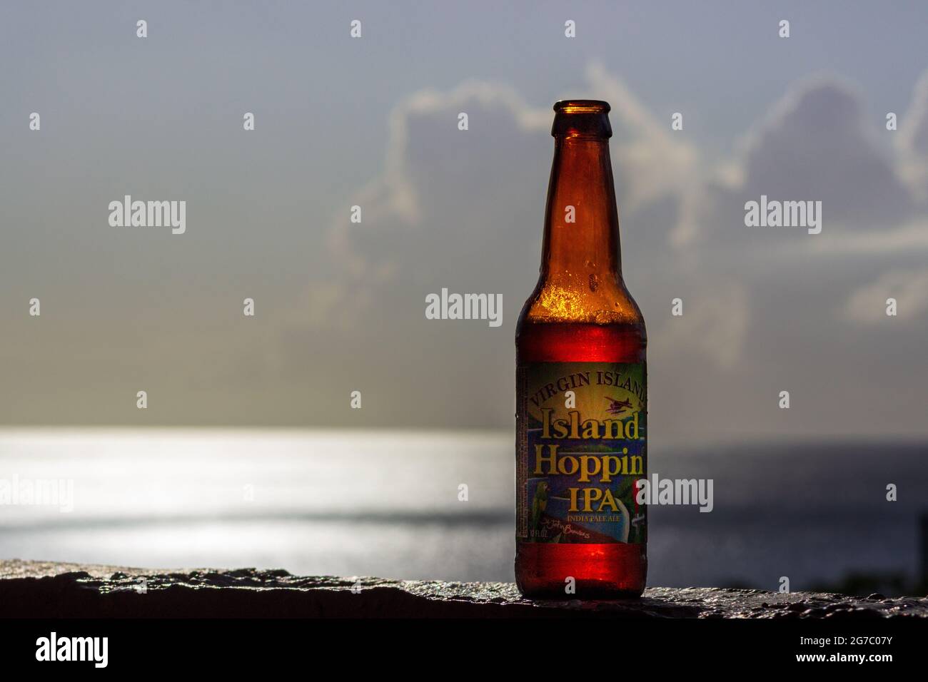 An ice cold Island Hoppin' IPA by St. John Brewers awaiting, with the glittering Caribbean Sea in the background equals a spectacular vacation. Stock Photo