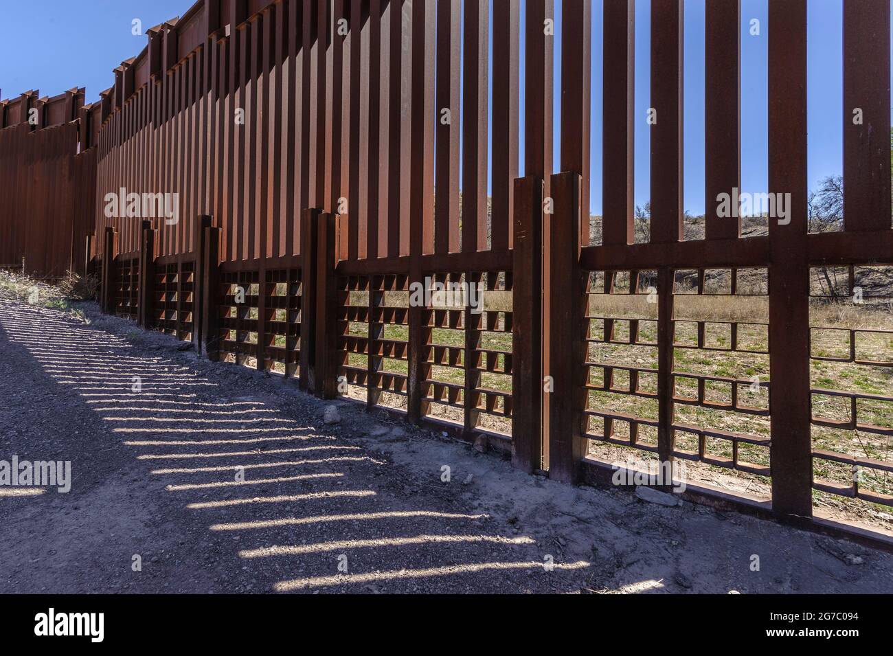 US border fence on the Mexico border, east of Nogales Arizona USA, and Nogales Sonora Mexico, viewed from US side, showing specialized structure to ac Stock Photo