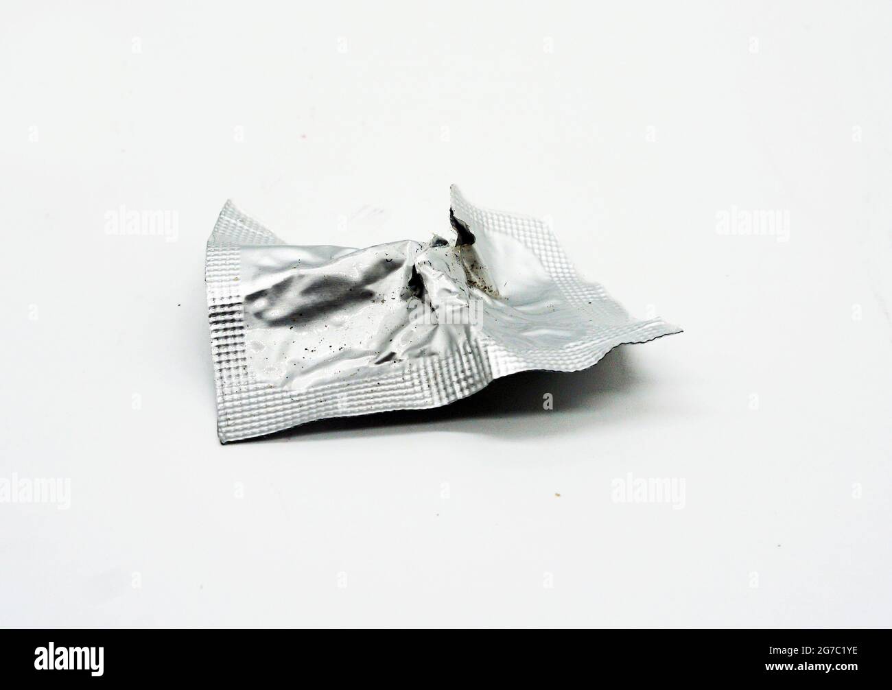 Used aluminum foil sachets will be disposed of in the trash. Stock Photo