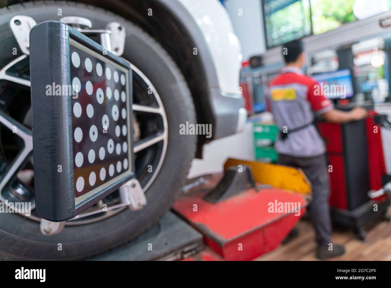 Wheel alignment equipment in a car repair station, Car Steering Wheel  Balancer Calibrate with laser reflector. Car concept Stock Photo - Alamy