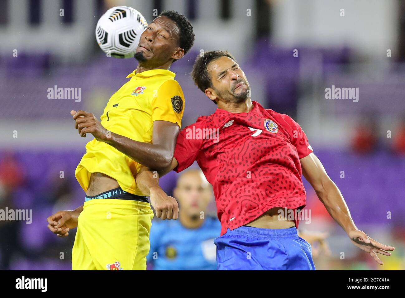 Orlando, Florida, USA. July 12, 2021: Guadeloupe midfielder MAVRICK ANNEROSE (7) gets a header against Costa Rica midfielder CELSO BORGES (5) during the 2021 Concacaf Gold Cup Costa Rica vs Guadeloupe soccer match at Exploria Stadium in Orlando, Fl on July 12, 2021. Credit: Cory Knowlton/ZUMA Wire/Alamy Live News Stock Photo