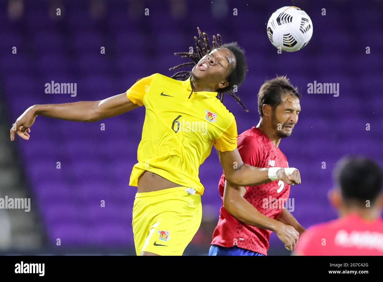 Orlando, Florida, USA. July 12, 2021: Guadeloupe midfielder QUENTIN ANNETTE (6) gets a header against Costa Rica midfielder CELSO BORGES (5) during the 2021 Concacaf Gold Cup Costa Rica vs Guadeloupe soccer match at Exploria Stadium in Orlando, Fl on July 12, 2021. Credit: Cory Knowlton/ZUMA Wire/Alamy Live News Stock Photo