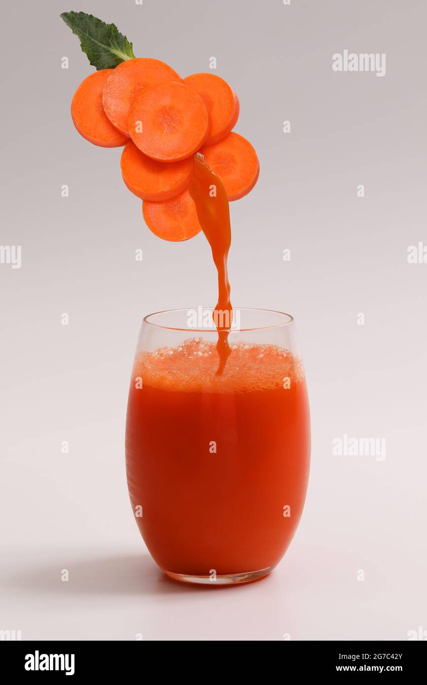 Cold press carrot juice with splash into a glass Stock Photo Alamy