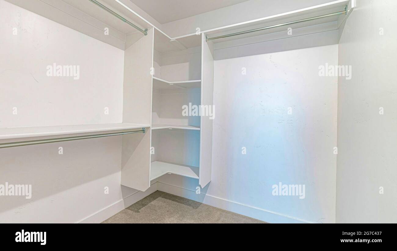 Pano Interior of a walk in closet with shelves and clothes rod mounted ...