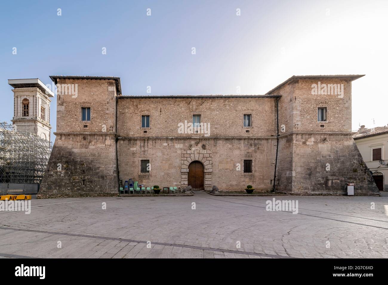 The facade of the ancient La Castellina palace and the bell tower of the cathedral, Norcia, Italy Stock Photo