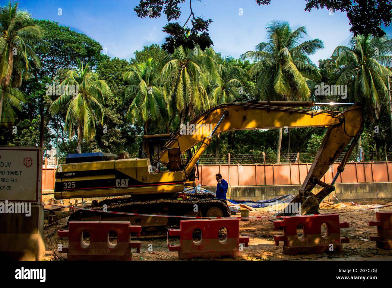 Metro rail working inside Dhaka University area.It is very disgraceful for us that we have to cut off some trees in order to make pillers Stock Photo