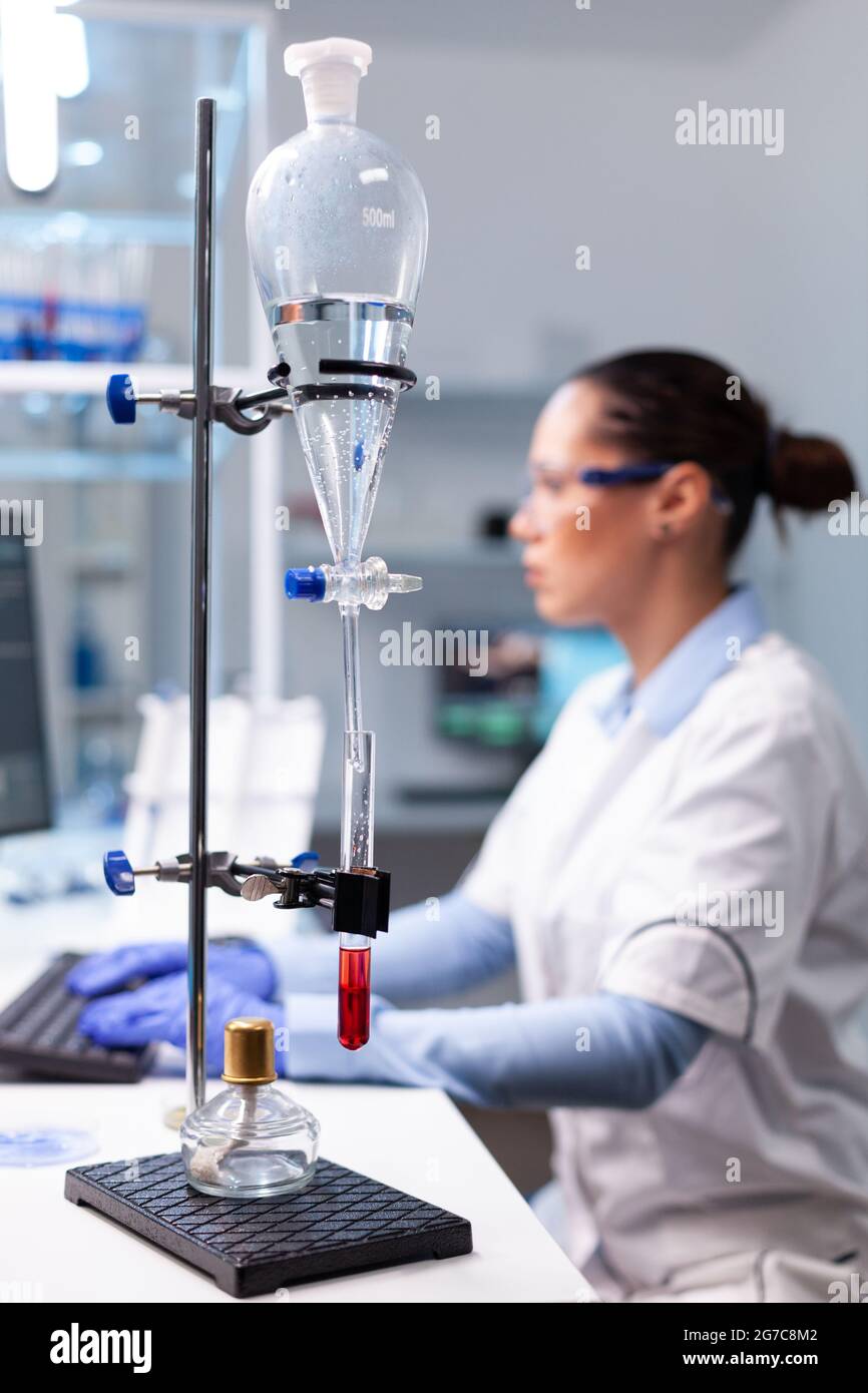 Specialist pharmacist woman typing bacteriology infection test results