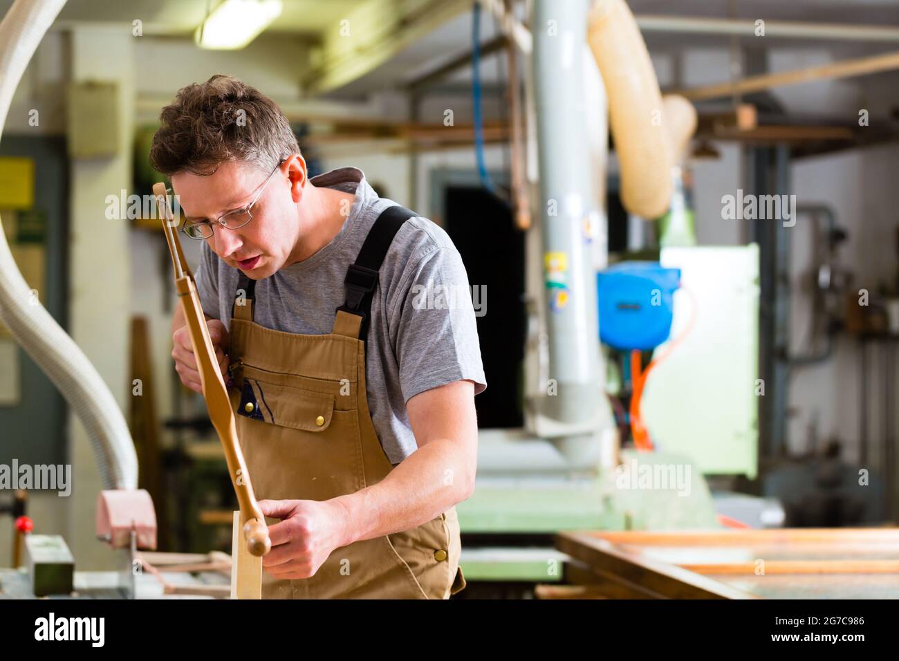 Carpenter working on a hand saw cutting a tenon in drawers in his ...