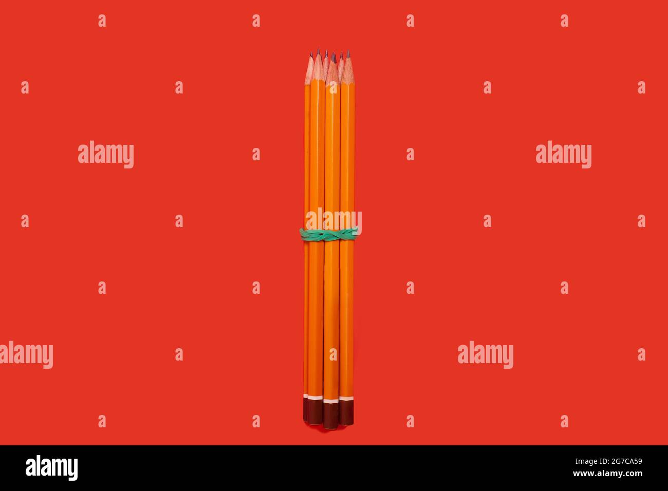 pencils lying on a red background. school accesories Stock Photo