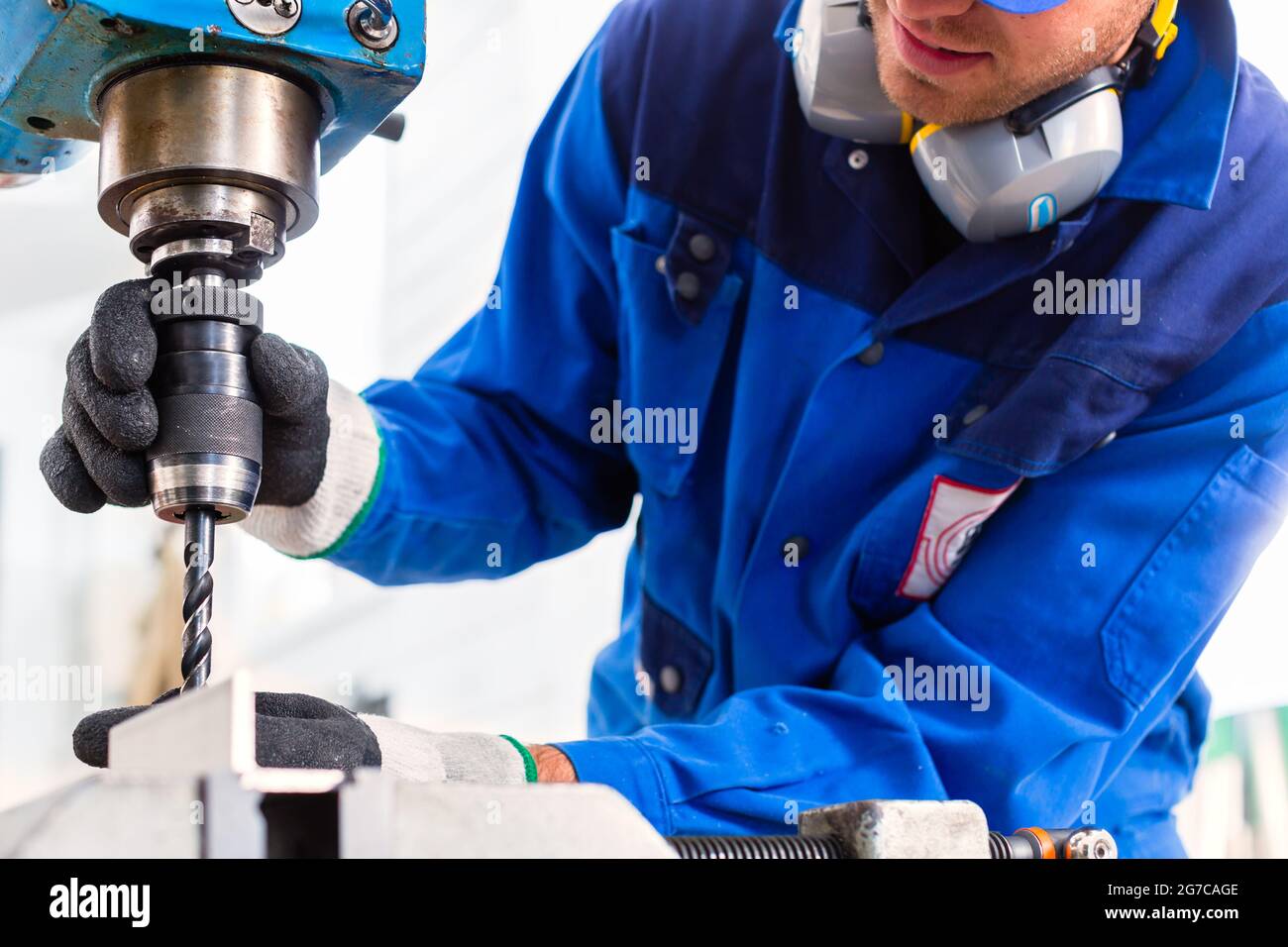 Craftsman drilling metal with drill in Stock Photo Alamy