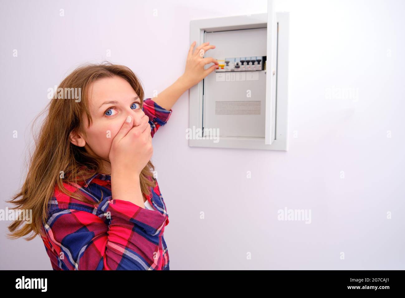 Housewife is afraid to turn on the switch in the shield with