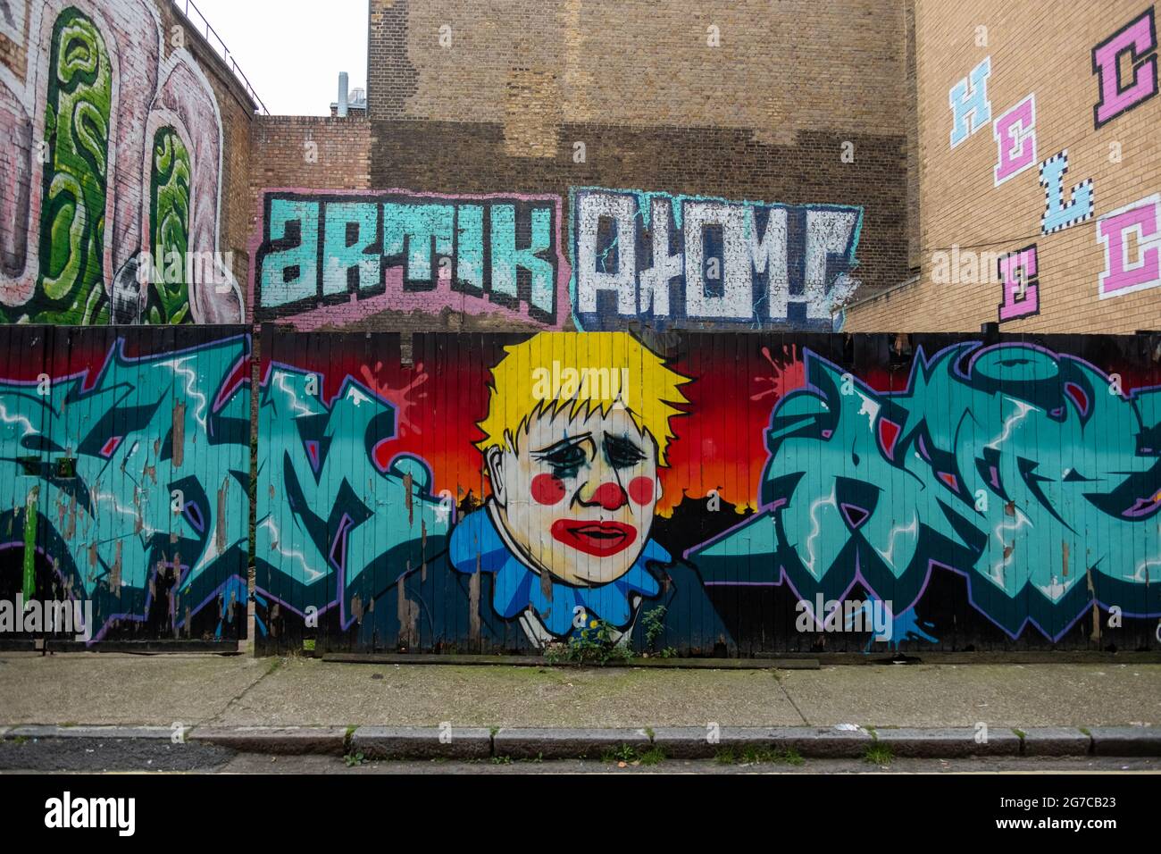 London- July, 2021: Graffiti art on wall in East London of Boris Johnson as a clown Stock Photo