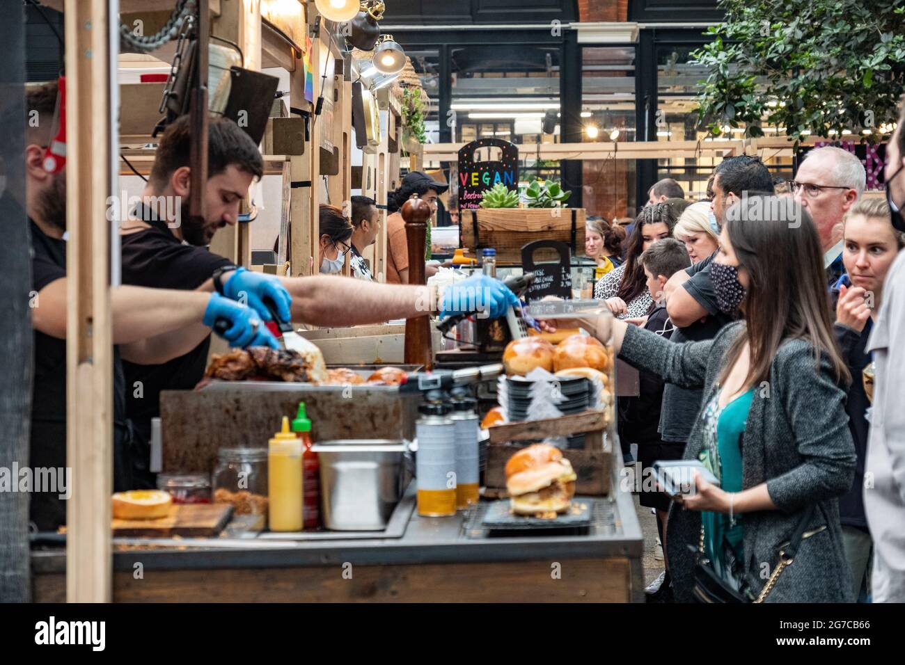 London- July, 2021: Food stalls inside Spitalfields Market.  A popular market with food, bars, arts and crafts Stock Photo