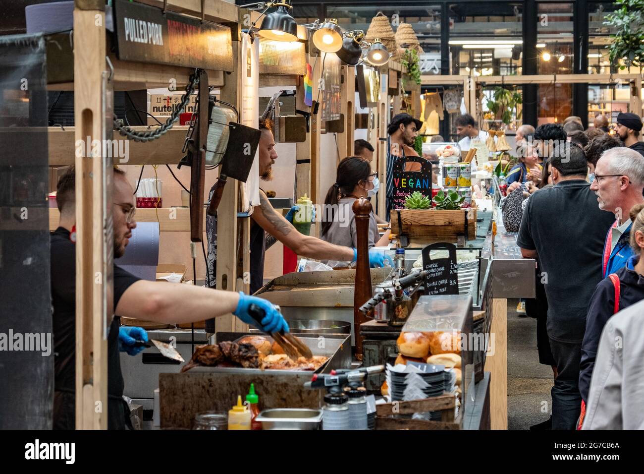 London- July, 2021: Food stalls inside Spitalfields Market.  A popular market with food, bars, arts and crafts Stock Photo