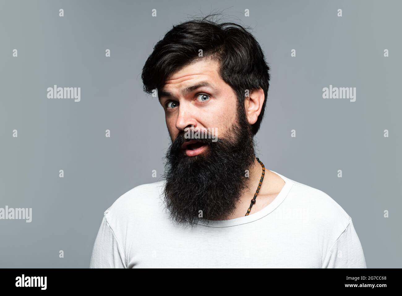 Surprised handsome bearded man. Man haircut, modern hair style. Close up  portrait of male model with long hair. Healthcare and hair care concept  Stock Photo - Alamy