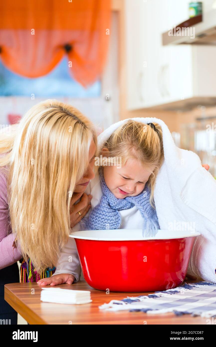 Mother care for sick child with vaporbath at domestic kitchen Stock
