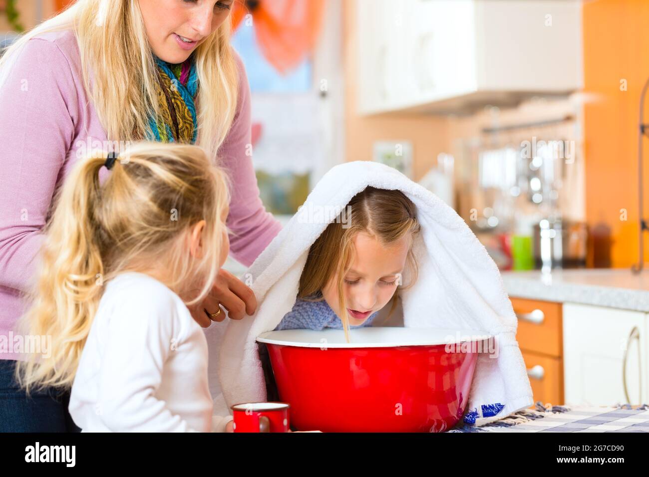 Mother care for sick child with vaporbath at domestic kitchen Stock