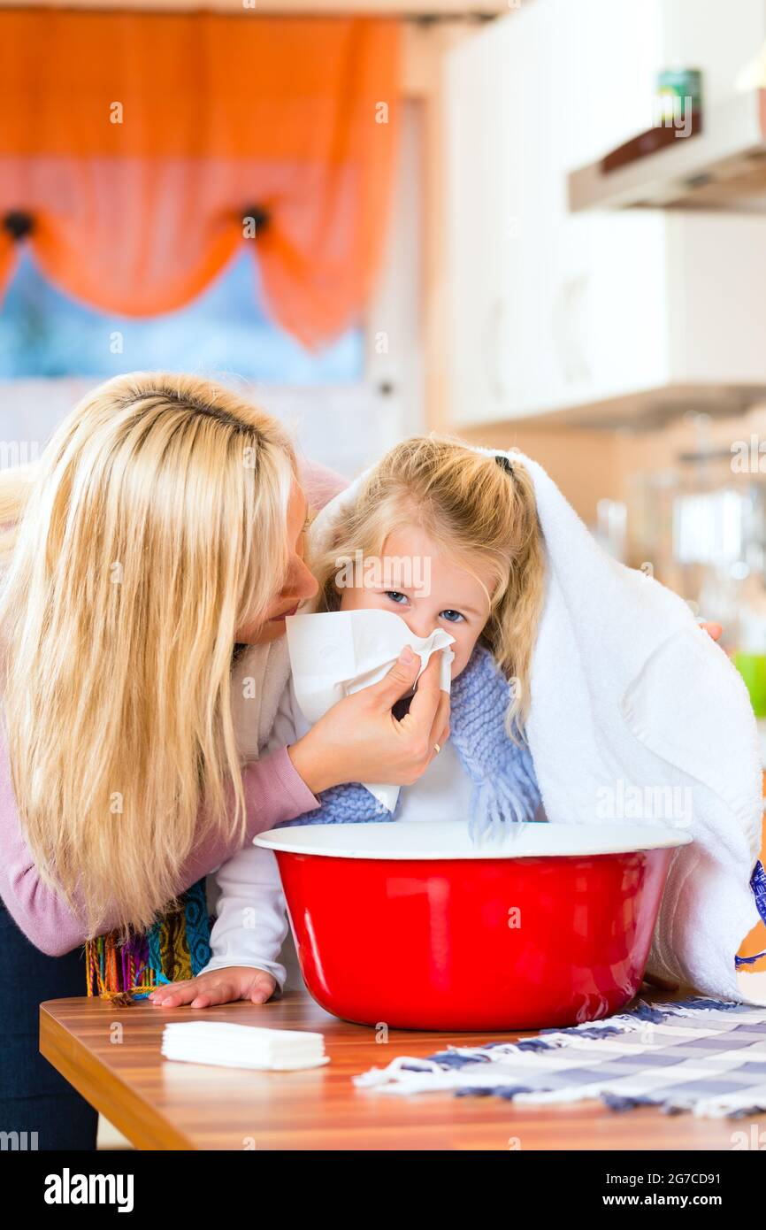 Mother care for sick child with vapor-bath at domestic kitchen Stock Photo