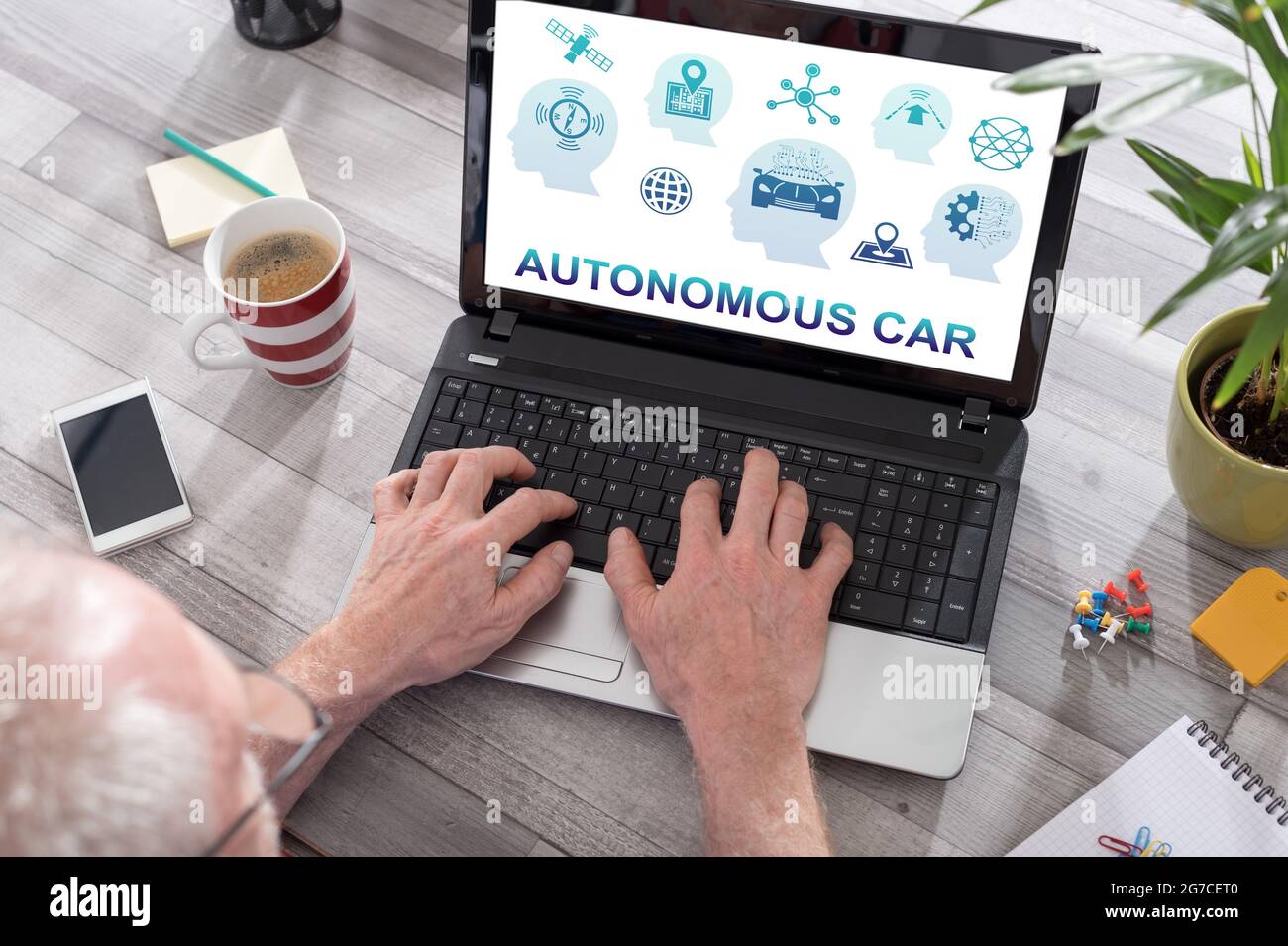 Autonomous car concept shown on a laptop used by a man Stock Photo