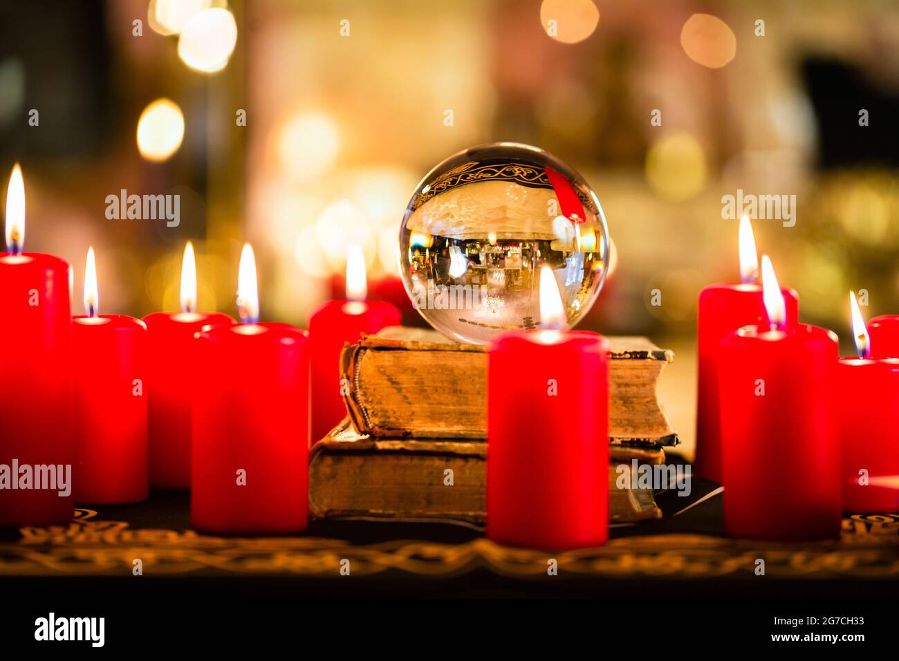 Crystal ball to prophesy or esoteric clairvoyance during a Seance in the candle light Stock Photo