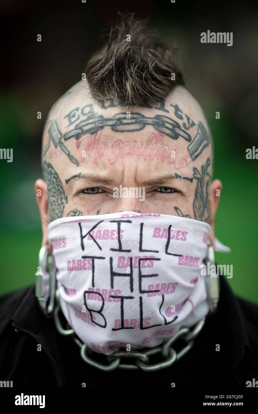 Headshot portrait of protester in face mask at a 'Kill the Bill' protest against new policing bill, Parliament Square, London, 5 July 2021 Stock Photo