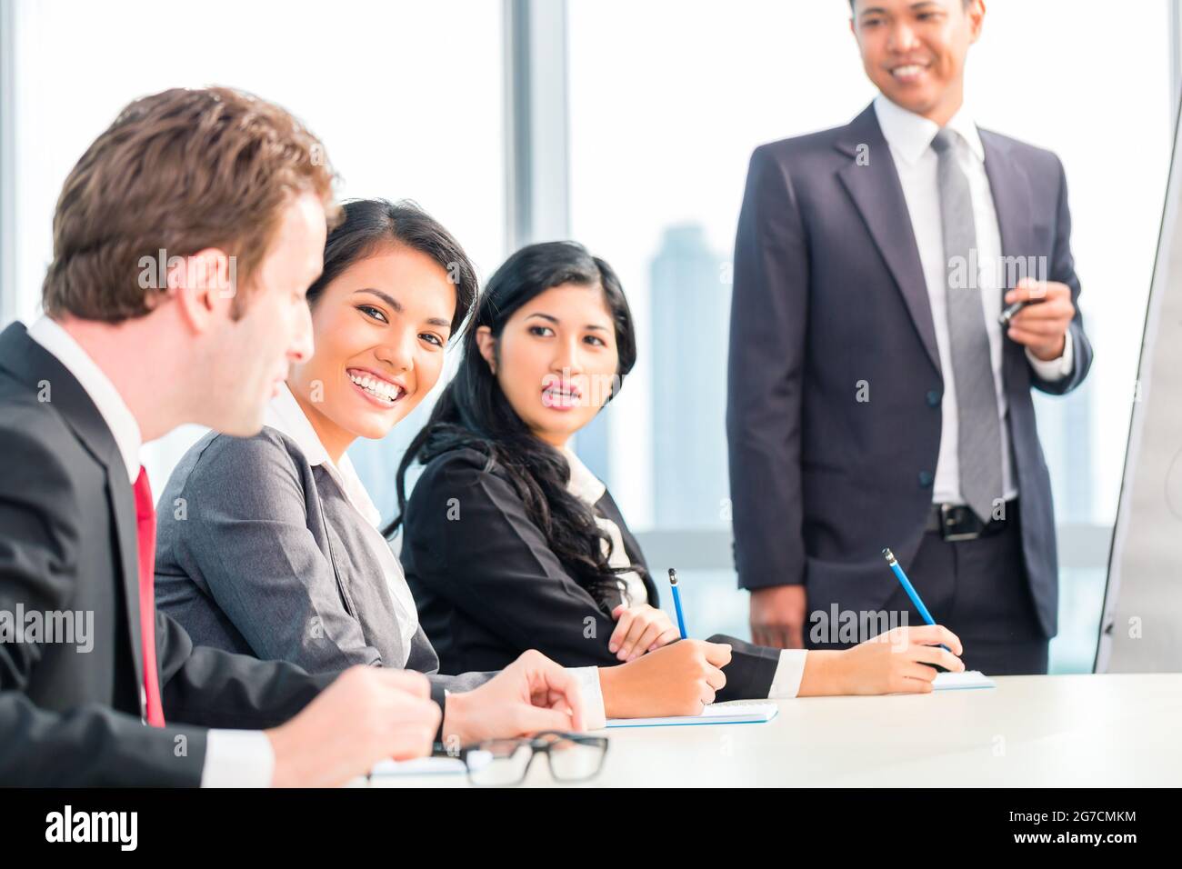 Asian business team in presentation discussing ideas Stock Photo