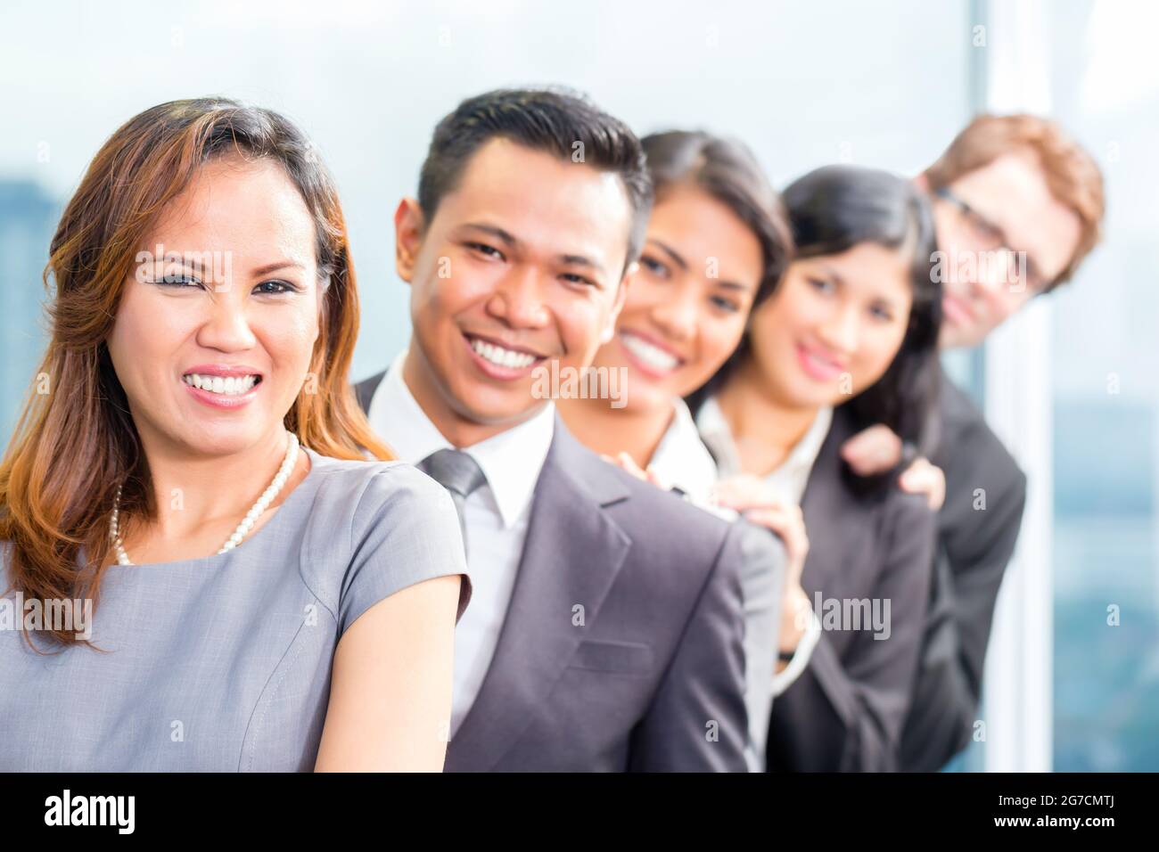 Portrait of smiling Asian business people standing in row Stock Photo ...
