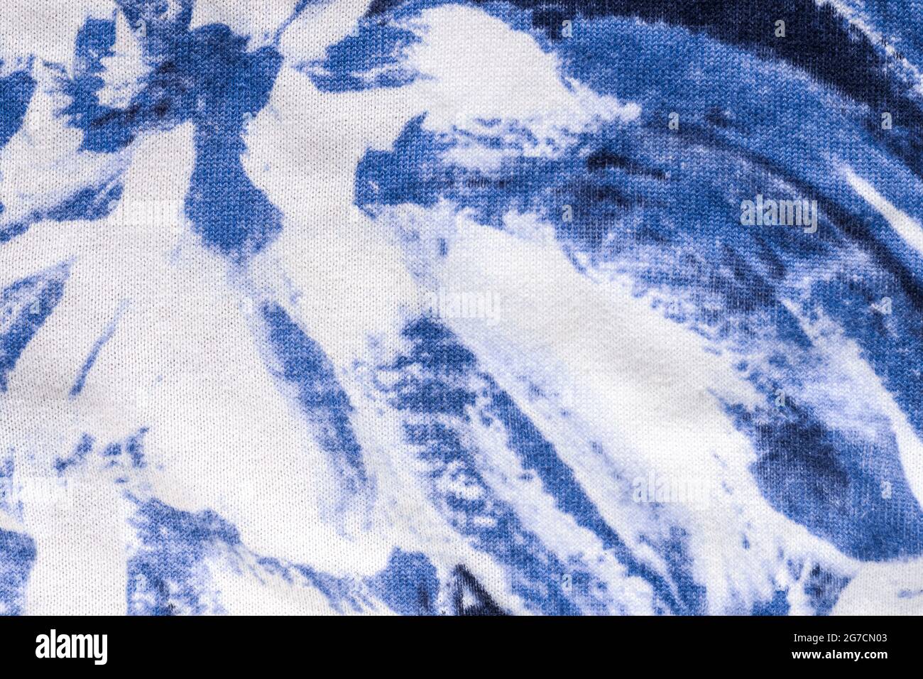 Tie-dye cotton fabric texture blue and white paint colors. Ancient resist-dyeing textile coloring technique, saturated primary colors, bold patterns, Stock Photo