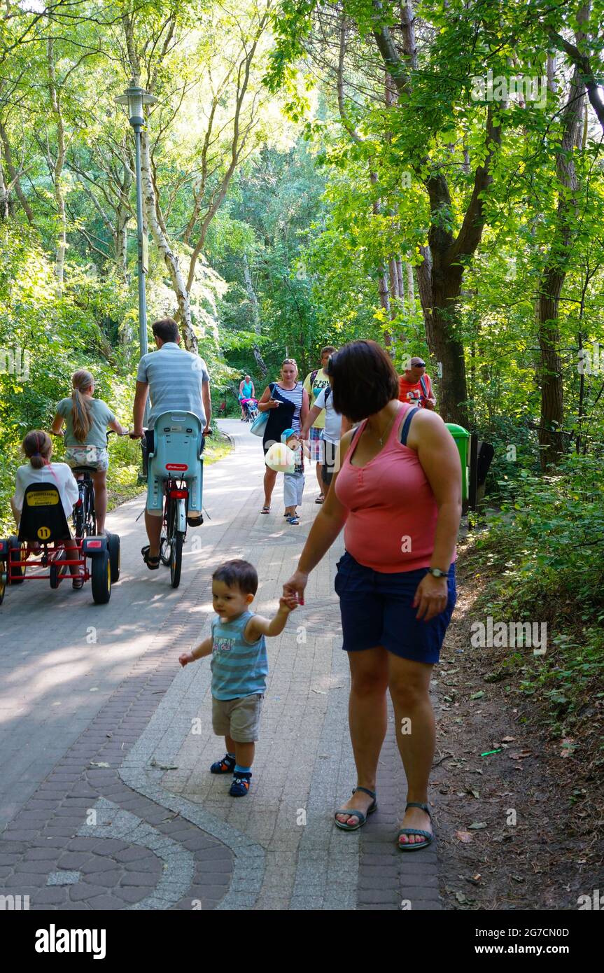 SIANOZETY, POLAND - Jul 22, 2015: A woman and child walking on a park footpath Stock Photo