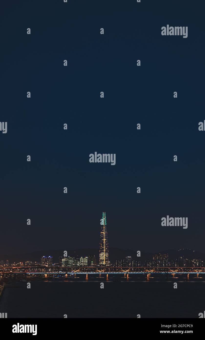Vertical shot of illuminated city at night Stock Photo