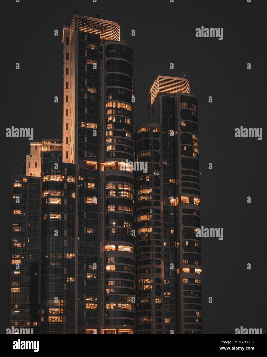 Vertical shot of an illuminated skyscraper at night Stock Photo