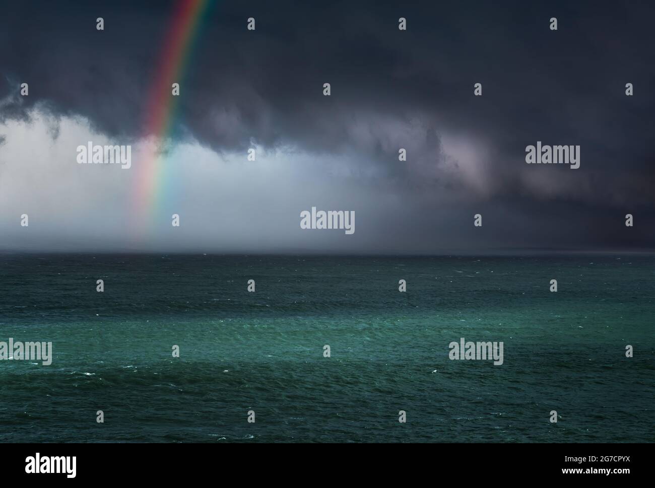 dramatic stormy clouds over the sea with a rainbow Stock Photo - Alamy