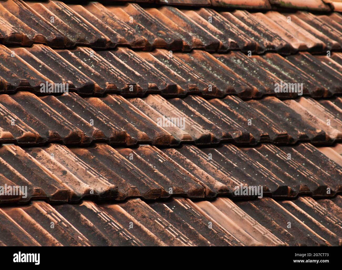 Closeup of an old dirty tile roof under the sunlight - great for wallpapers and textures Stock Photo
