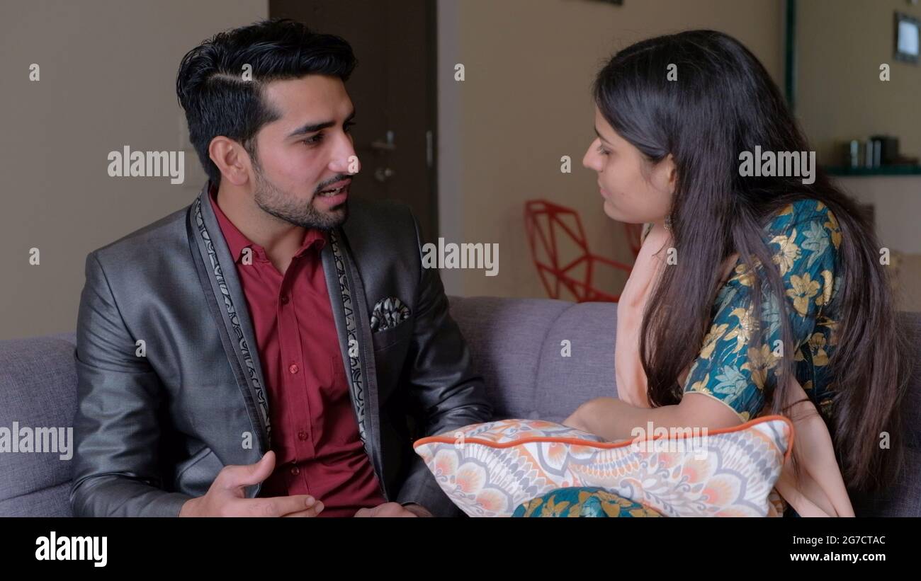 Shallow focus of an Indian man and woman talking to each other Stock ...
